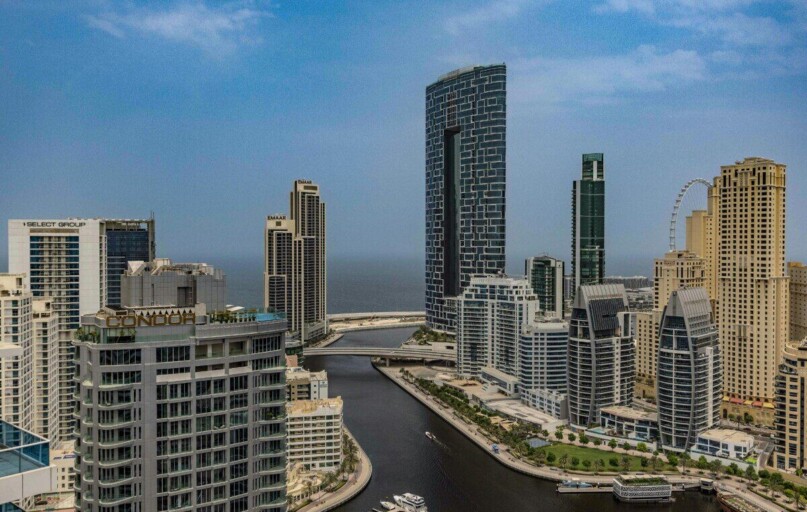 A breathtaking aerial view of Dubai Marina skyline with towering skyscrapers and beautiful canal.