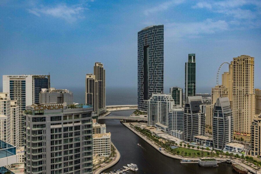 A breathtaking aerial view of Dubai Marina skyline with towering skyscrapers and beautiful canal.