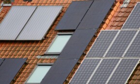 Close-up of solar panels on a tiled roof, showcasing sustainable energy solutions.