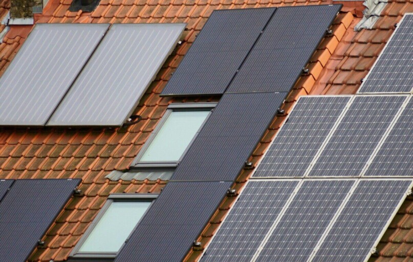 Close-up of solar panels on a tiled roof, showcasing sustainable energy solutions.