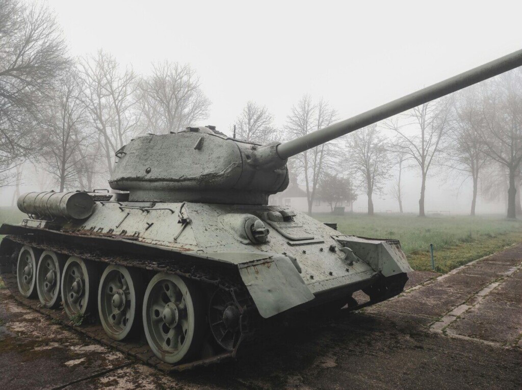 Soviet T-34 tank displayed outdoors on a foggy winter morning surrounded by trees.