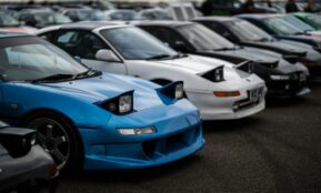 Toyota MR2 sports cars with popup headlights showcased at a car meet in England.