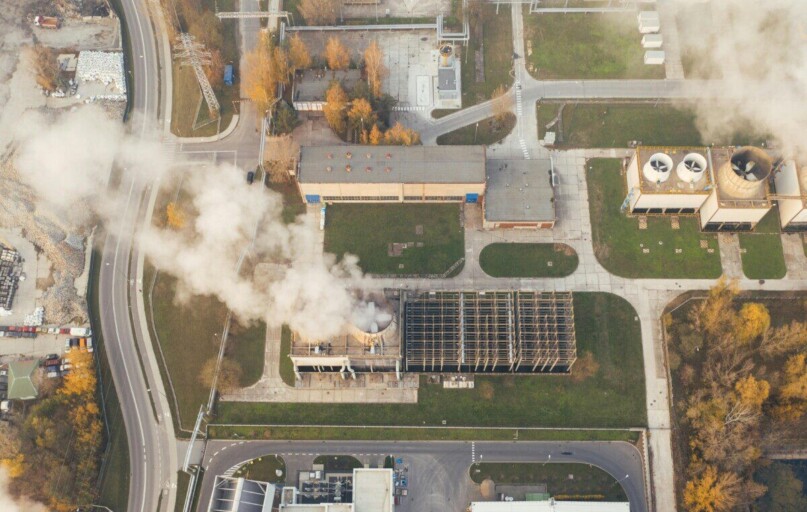 Aerial shot of an industrial area with visible smoke emissions in Poznań, Poland.