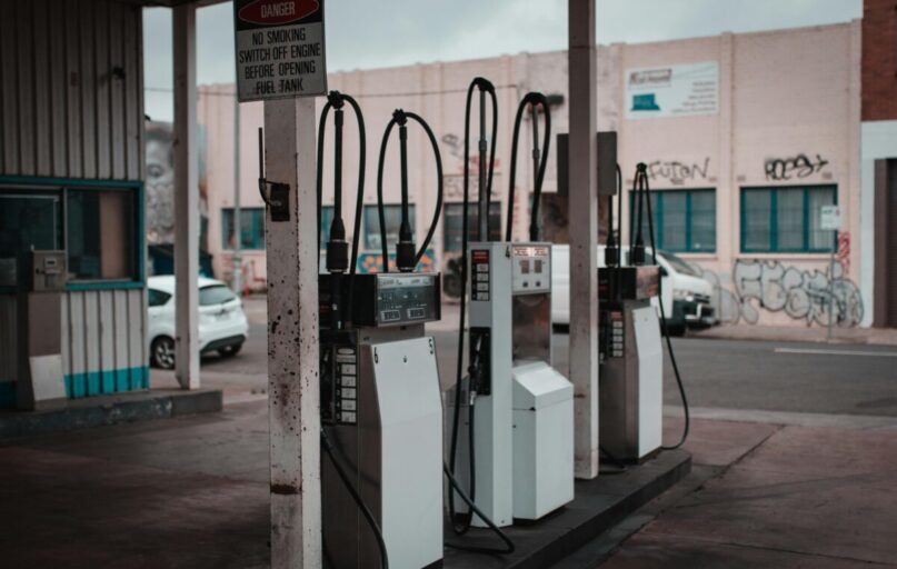 Empty gas station with visible graffiti in Collingwood, Australia.