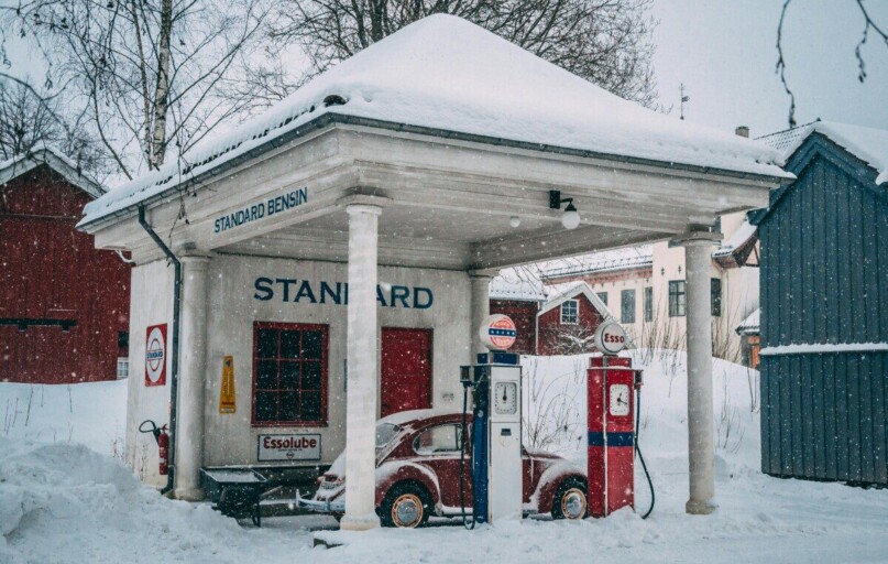 A vintage gas station covered in snow during a winter day in Oslo, Norway.