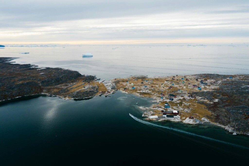 Stunning aerial view of a coastal town on a remote peninsula surrounded by ocean.