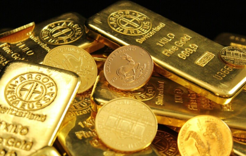 A detailed image of gold bars and coins symbolizing wealth and financial investment.