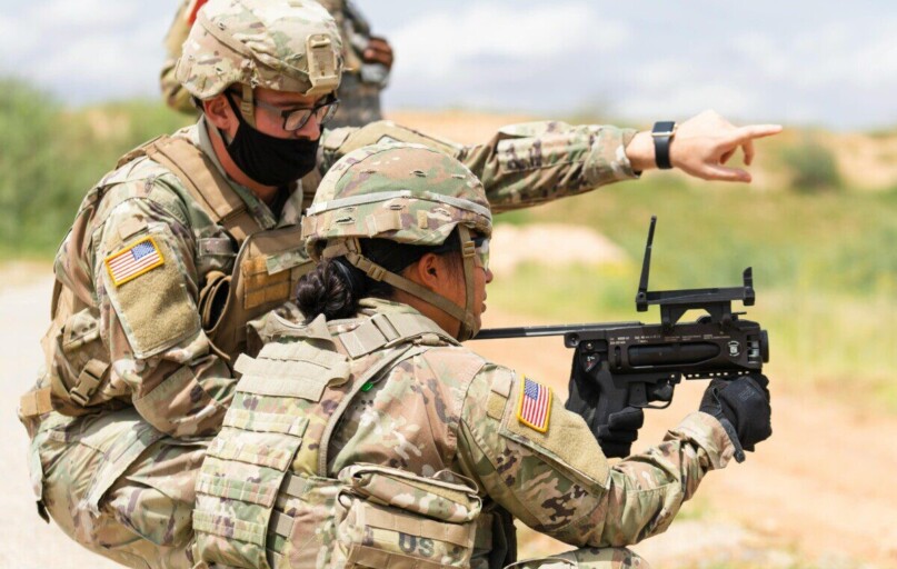 Two US soldiers engage in outdoor combat training, focusing on weapon proficiency.