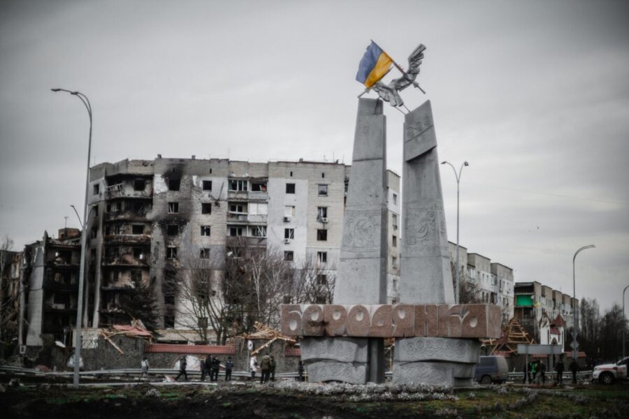 A monument stands beside war-torn buildings in Borodyanka, Ukraine.