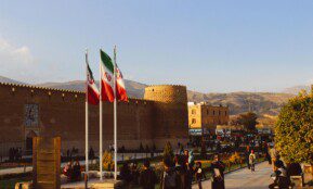 Karim Khan Citadel with Iranian flags in Shiraz, Iran at sunset.