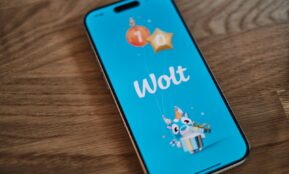 A phone with the word woot on it sitting on a table