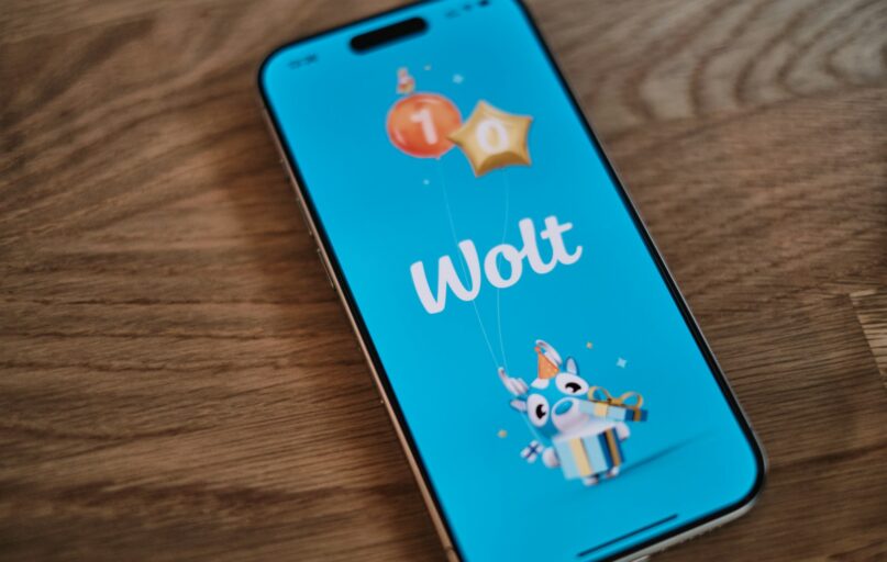 A phone with the word woot on it sitting on a table