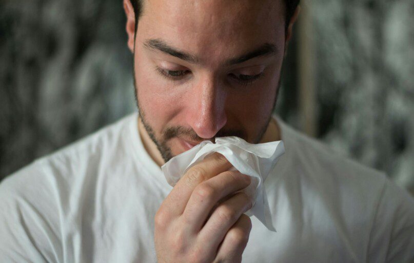 man wiping mouse with tissue paper