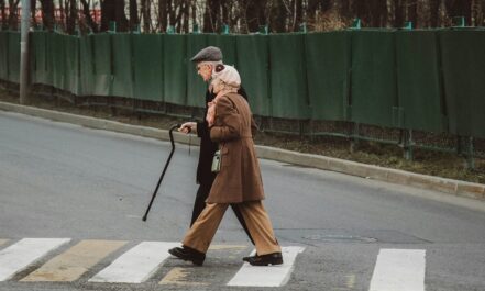man and woman walking on pedestrian line during daytime