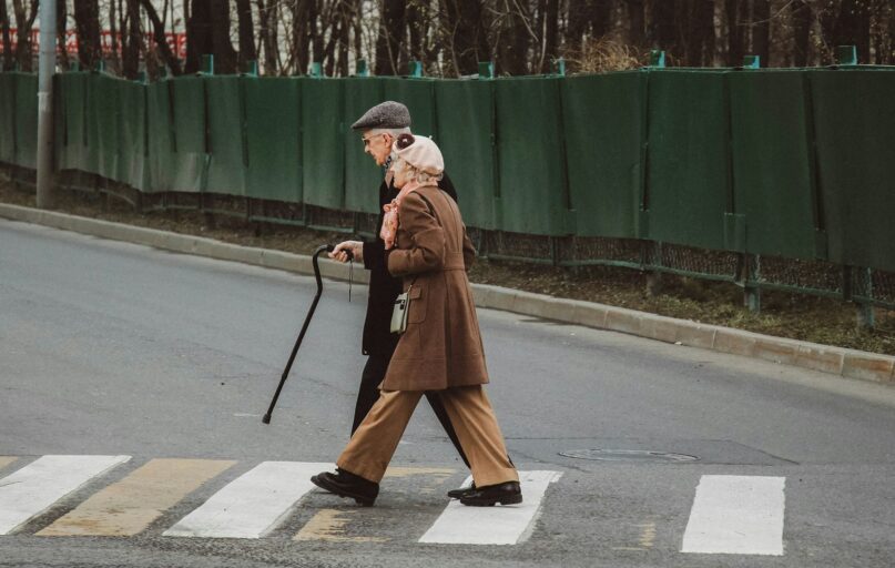 man and woman walking on pedestrian line during daytime