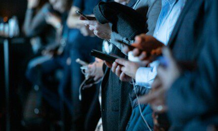 people using phone while standing