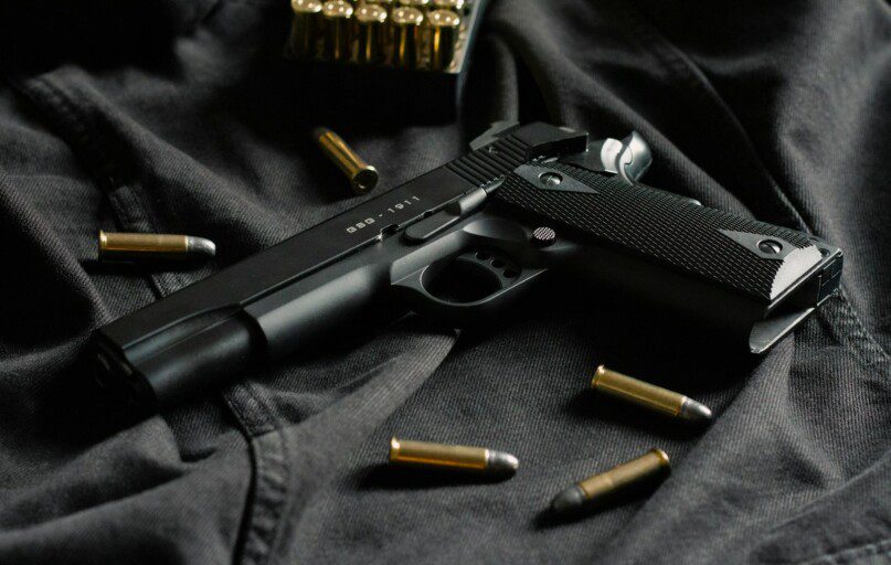 black semi automatic pistol on black textile