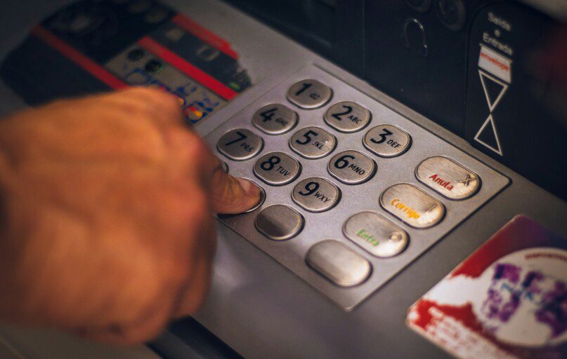 person holding white and red card