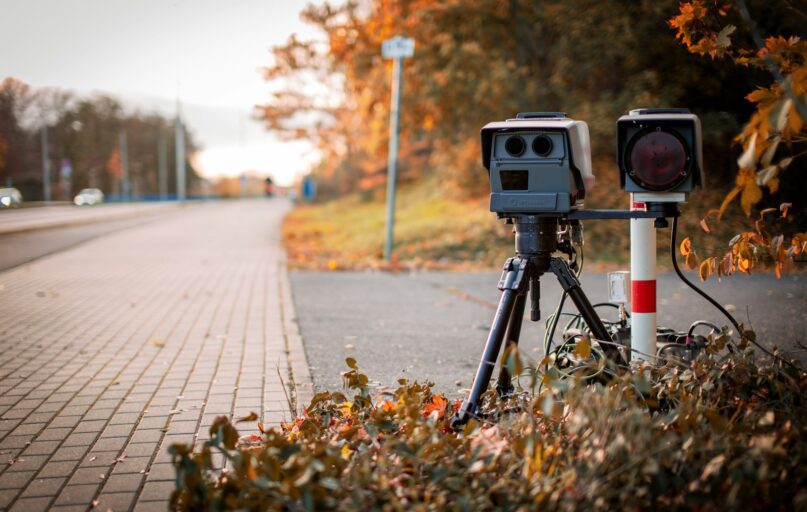 black and gray camera on tripod on road during daytime