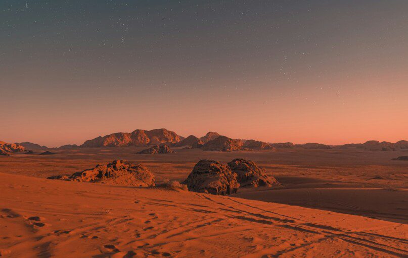 brown sand under blue sky during night time