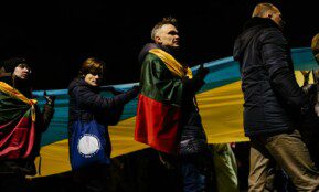 a group of people standing around each other