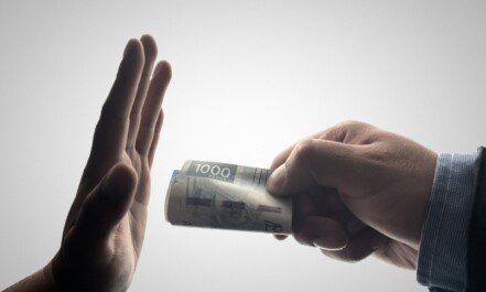 a person holding a stack of cash