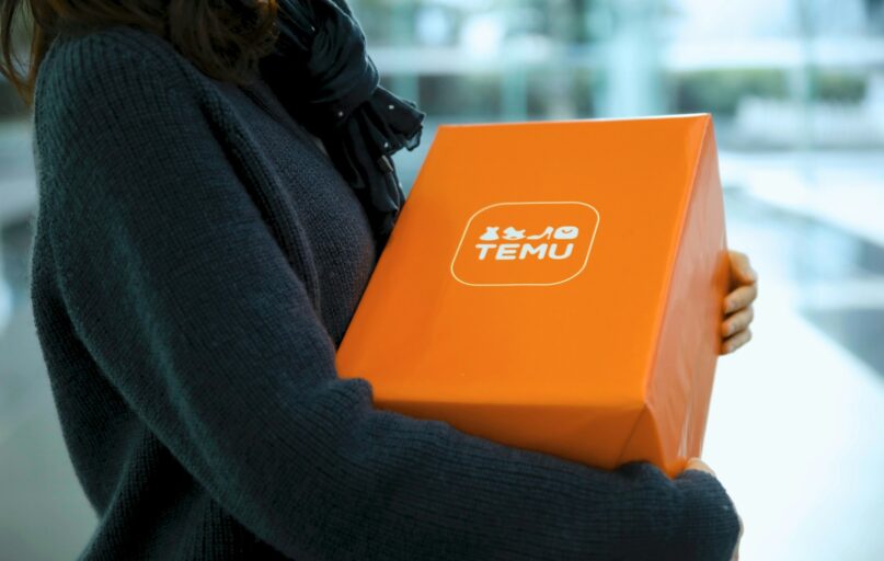 Woman holding an orange temu package