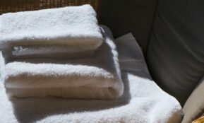 Stack of clean white towels on a surface.