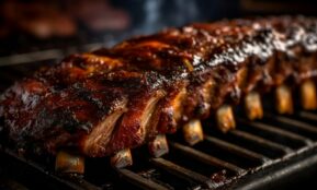 a rack of ribs cooking on a grill
