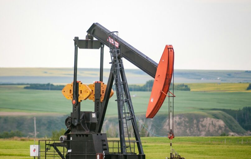 black and orange metal machine on green grass field during daytime