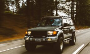 timelapse photography of green SUV on road
