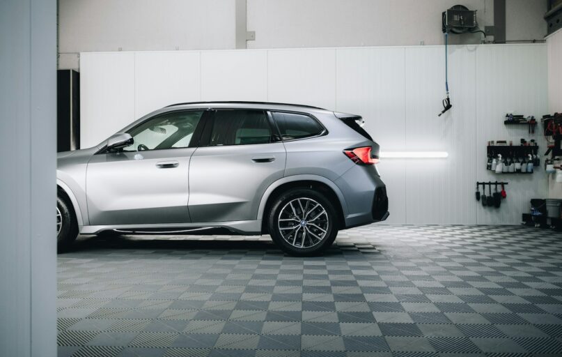 a silver bmw suv parked in a garage