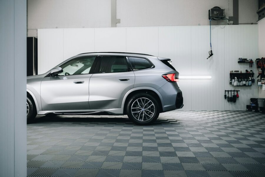 a silver bmw suv parked in a garage
