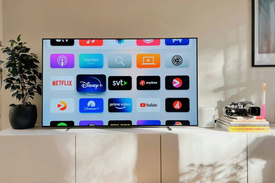 a flat screen tv sitting on top of a white cabinet