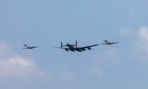 black and red jet plane in mid air during daytime