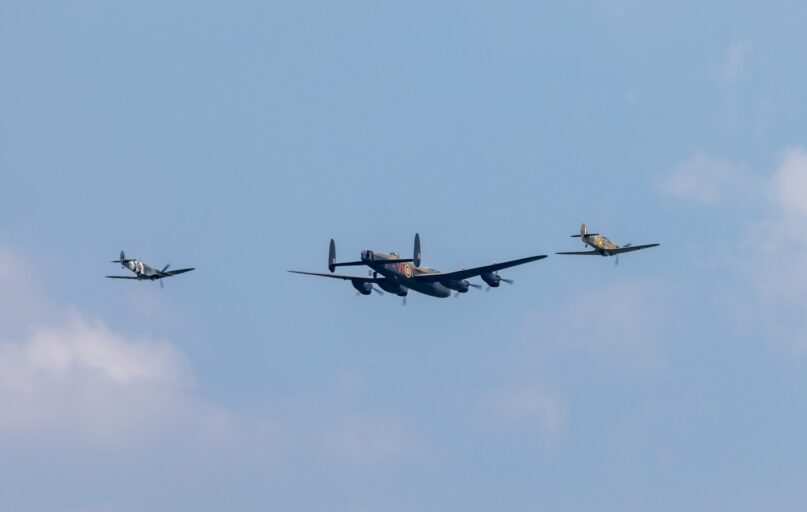 black and red jet plane in mid air during daytime