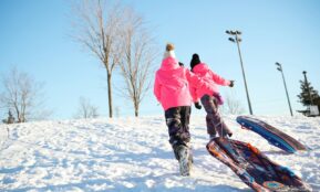 a couple of people that are standing in the snow