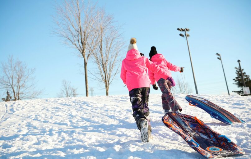 a couple of people that are standing in the snow
