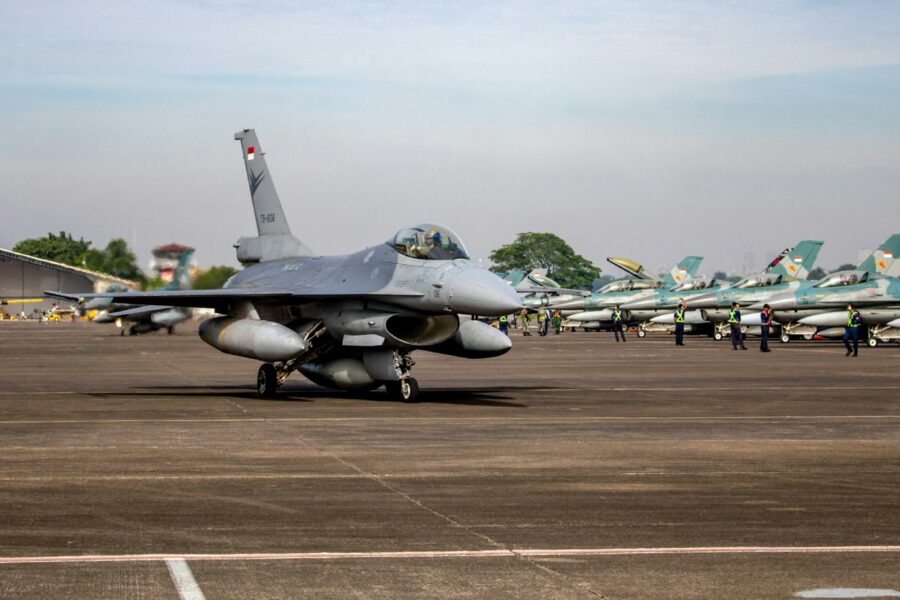a fighter jet sitting on top of an airport tarmac