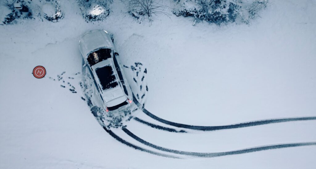 an aerial view of a car in the snow