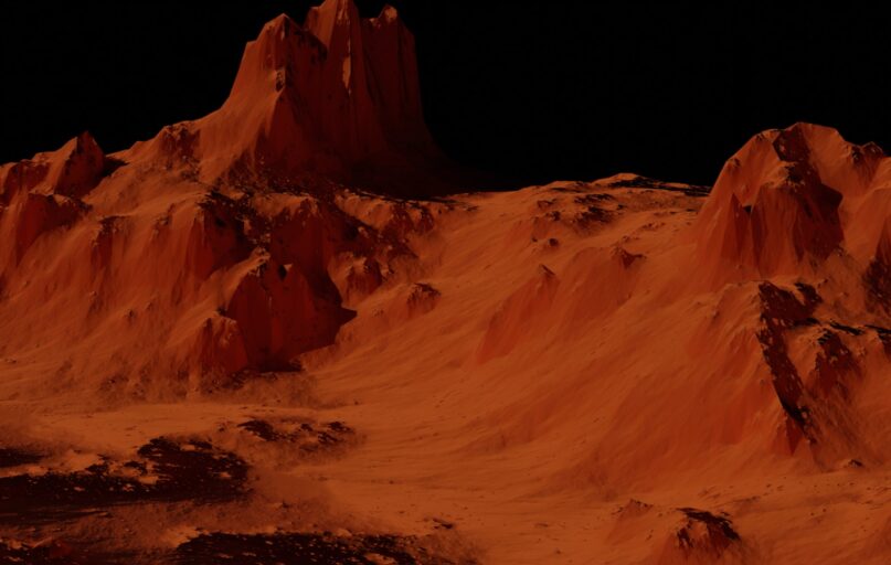 a group of mountains covered in sand at night
