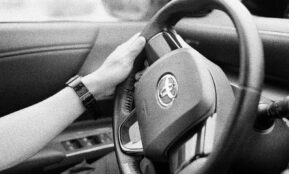 person holding black steering wheel