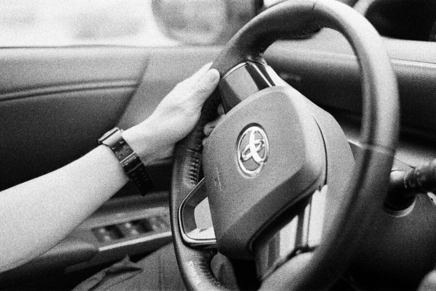 person holding black steering wheel
