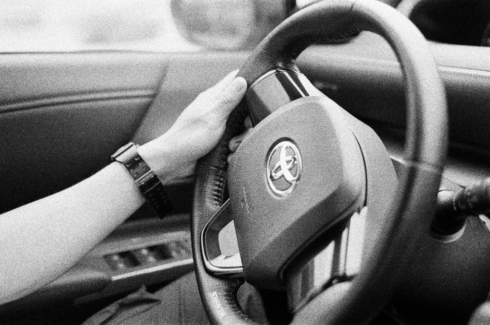 person holding black steering wheel
