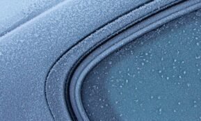 a close up of a car's windshield with drops of water on it