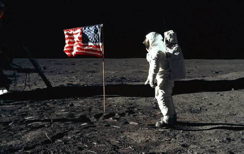 Buzz Aldrin on the moon in front of the US flag
