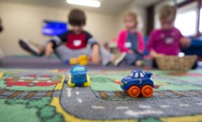 a group of children playing with toys on the floor
