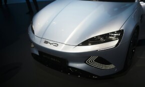 a white sports car is on display at a car show