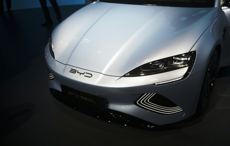 a white sports car is on display at a car show