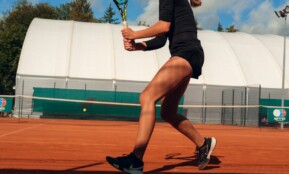 Woman playing tennis on a clay court